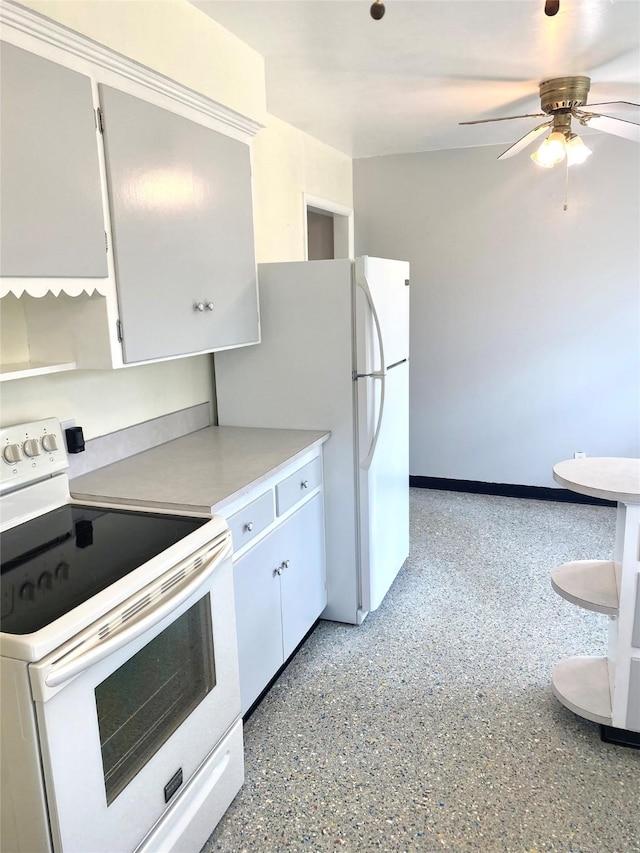 kitchen featuring light countertops, a ceiling fan, light speckled floor, and white appliances