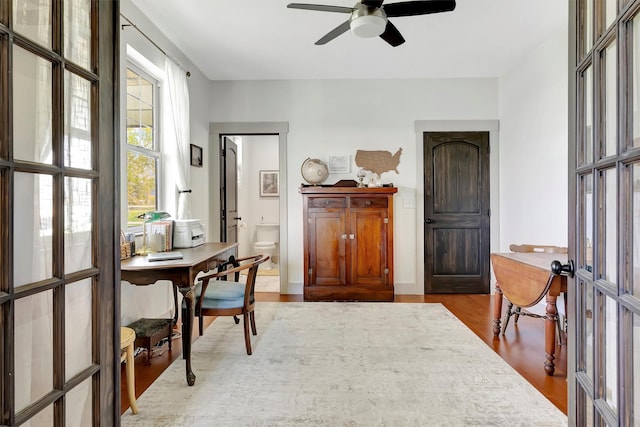 office space featuring french doors, ceiling fan, and wood finished floors