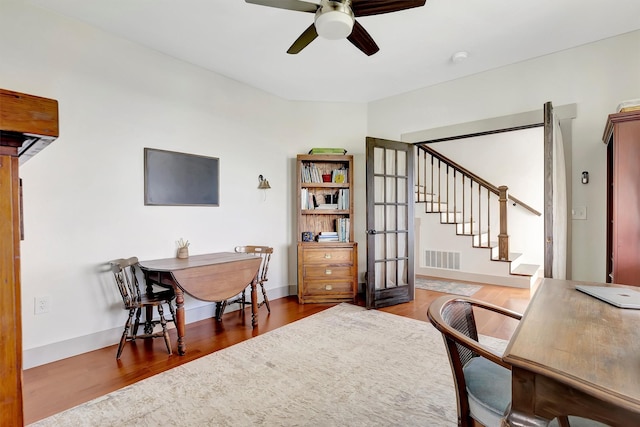 office featuring visible vents, wood finished floors, baseboards, french doors, and a ceiling fan
