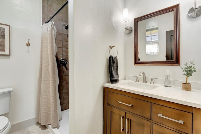 bathroom featuring vanity, toilet, baseboards, and a stall shower