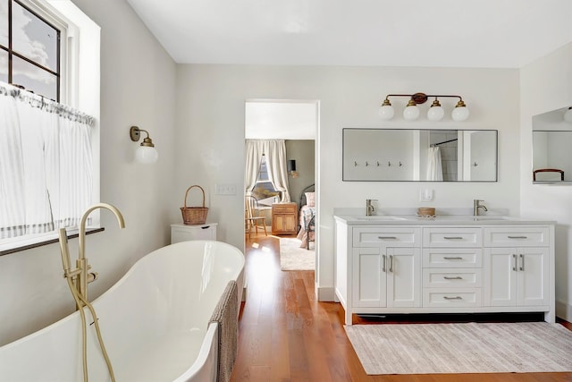 685 Hollibaugh Rd, Stevensville, MT 59870 - full bath with wood finished floors, double vanity, and a freestanding bath