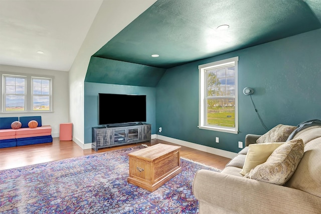 685 Hollibaugh Rd, Stevensville, MT 59870 - living area featuring healthy amount of natural light, wood finished floors, vaulted ceiling, a textured ceiling, and recessed lighting