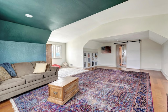 685 Hollibaugh Rd, Stevensville, MT 59870 - living area with a barn door, wood finished floors, lofted ceiling, and built in shelves