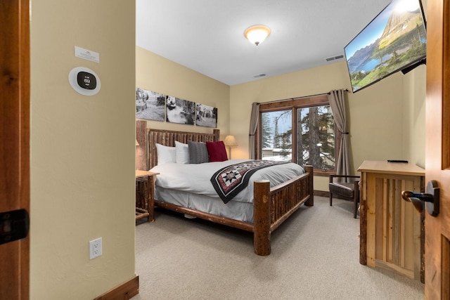 bedroom featuring visible vents, baseboards, and light colored carpet