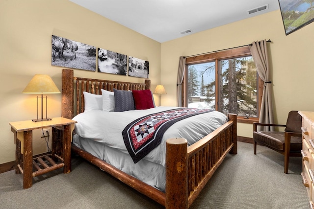 carpeted bedroom featuring baseboards and visible vents