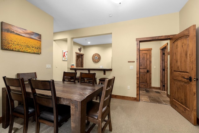 carpeted dining space with recessed lighting and baseboards