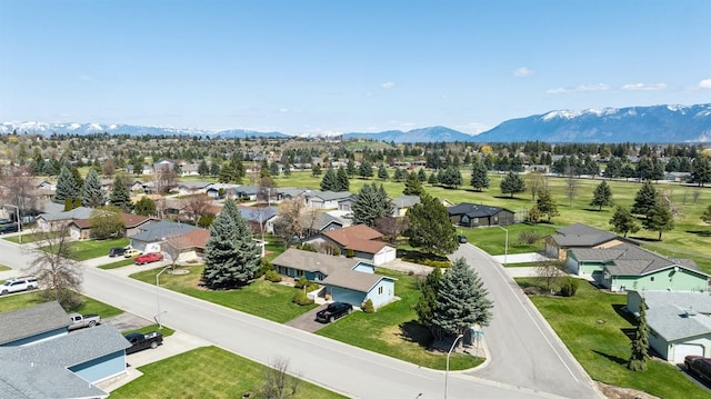 drone / aerial view featuring a residential view and a mountain view