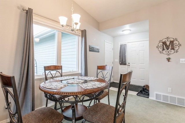 dining room with visible vents, carpet, baseboards, and a chandelier