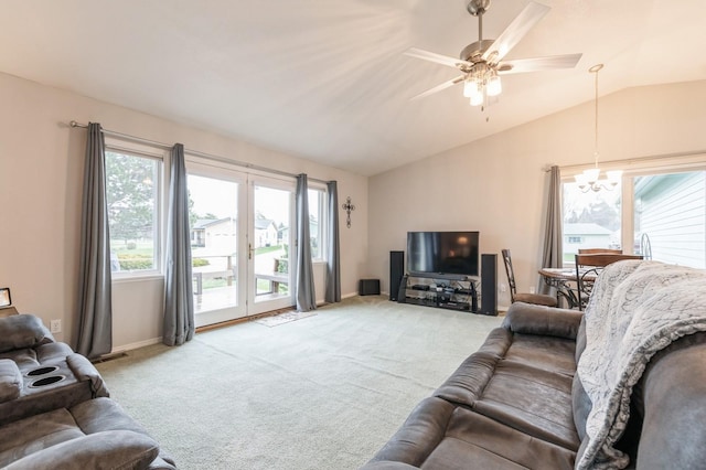 living room with baseboards, light carpet, ceiling fan with notable chandelier, and lofted ceiling