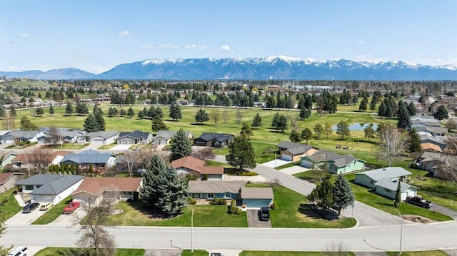 drone / aerial view featuring a water and mountain view and a residential view