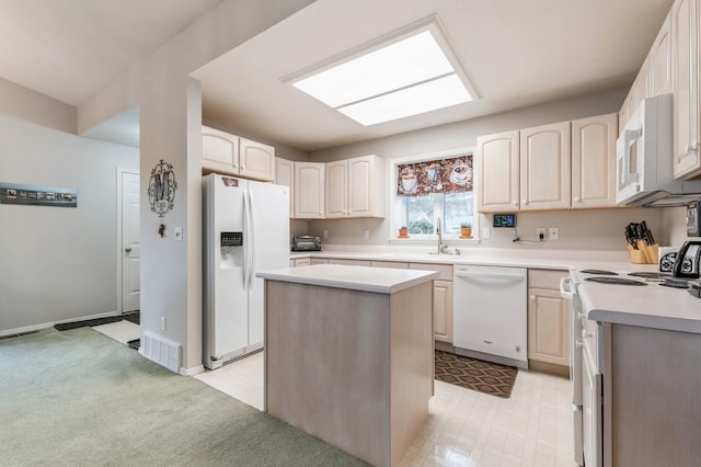 kitchen with white appliances, visible vents, a sink, and light countertops