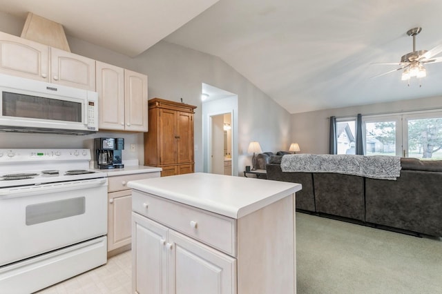 kitchen with white appliances, open floor plan, light countertops, a ceiling fan, and vaulted ceiling
