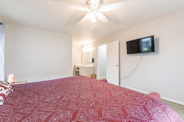 carpeted bedroom featuring a ceiling fan, baseboards, and ensuite bath