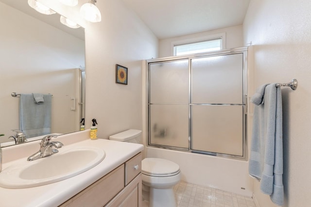 bathroom with toilet, shower / bath combination with glass door, and vanity