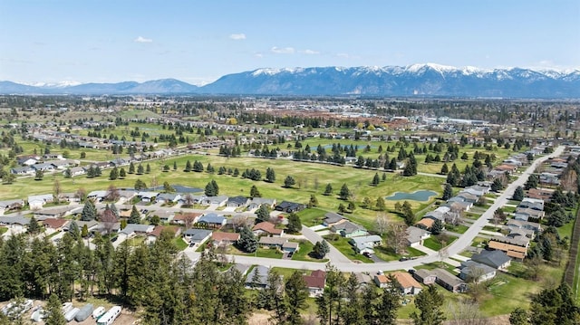 drone / aerial view featuring a water and mountain view and a residential view