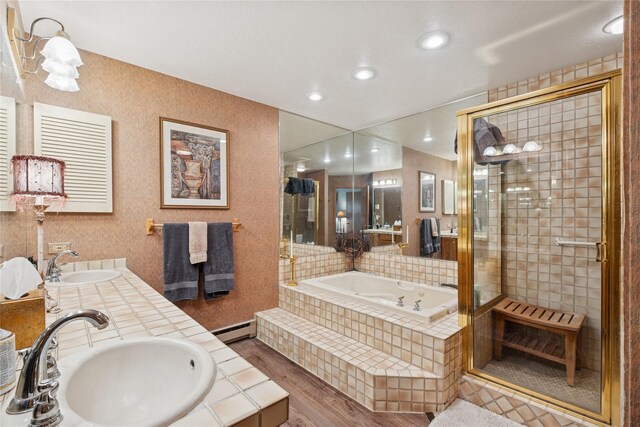 85 Golf Ter, Bigfork, MT 59911 - full bath featuring wood finished floors, a garden tub, a baseboard heating unit, a stall shower, and recessed lighting