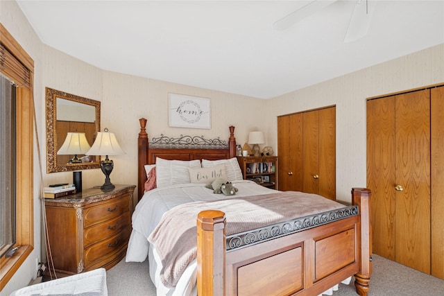 85 Golf Ter, Bigfork, MT 59911 - carpeted bedroom with multiple closets, wallpapered walls, and a ceiling fan