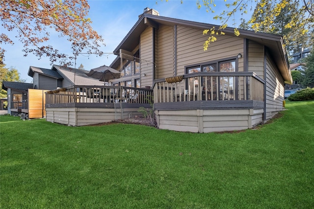 85 Golf Ter, Bigfork, MT 59911 - rear view of house with a deck, a yard, and a chimney