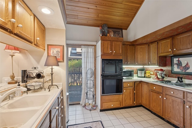 85 Golf Ter, Bigfork, MT 59911 - kitchen with black appliances, a sink, light tile patterned flooring, wood ceiling, and light countertops