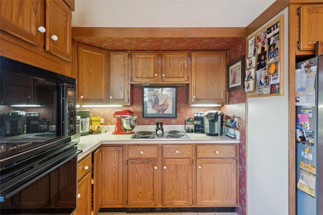 85 Golf Ter, Bigfork, MT 59911 - kitchen with appliances with stainless steel finishes, light countertops, and brown cabinetry