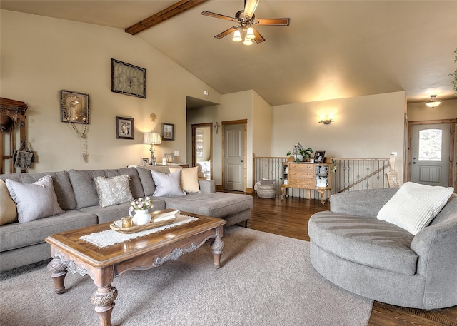 living area featuring vaulted ceiling with beams, ceiling fan, and wood finished floors