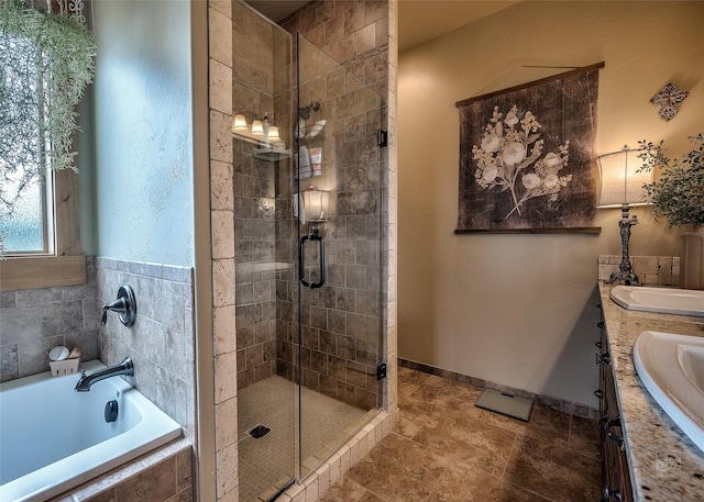 bathroom with a garden tub, double vanity, a sink, and a shower stall