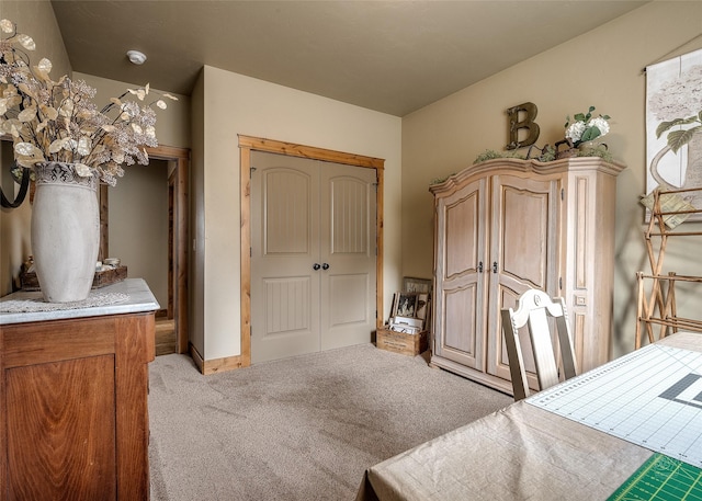 bedroom with light carpet and a closet