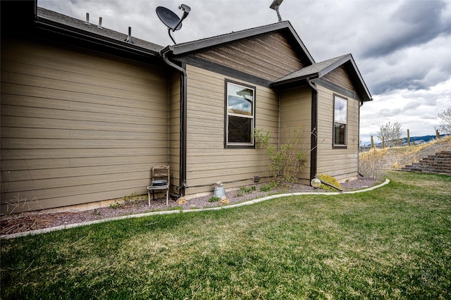 view of side of home featuring a lawn