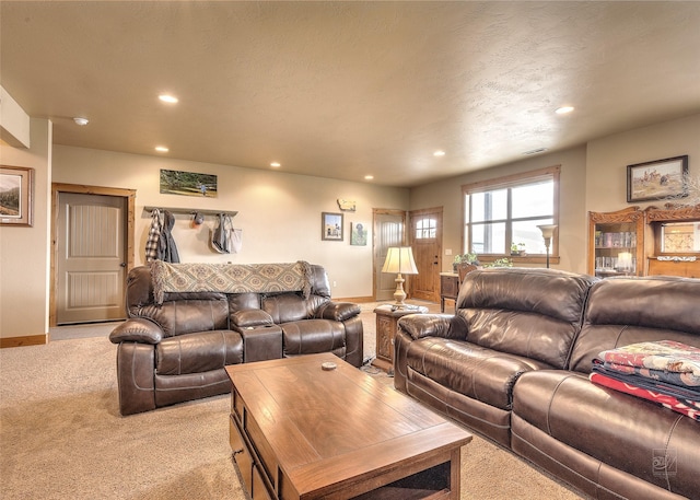 living area with recessed lighting, baseboards, and light colored carpet