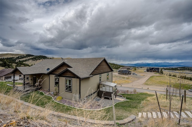 view of home's exterior with roof with shingles