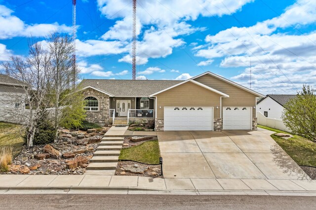 3201 12th St NE, Great Falls, MT 59404 - ranch-style house featuring a garage, fence, stone siding, a porch, and driveway