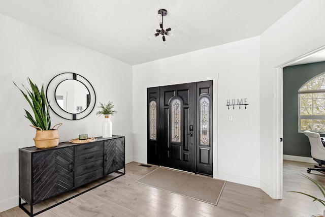 3201 12th St NE, Great Falls, MT 59404 - foyer with an inviting chandelier, baseboards, and light wood-style flooring