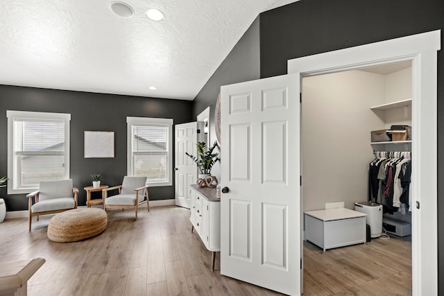 3201 12th St NE, Great Falls, MT 59404 - sitting room with baseboards, recessed lighting, a textured ceiling, light wood finished floors, and vaulted ceiling