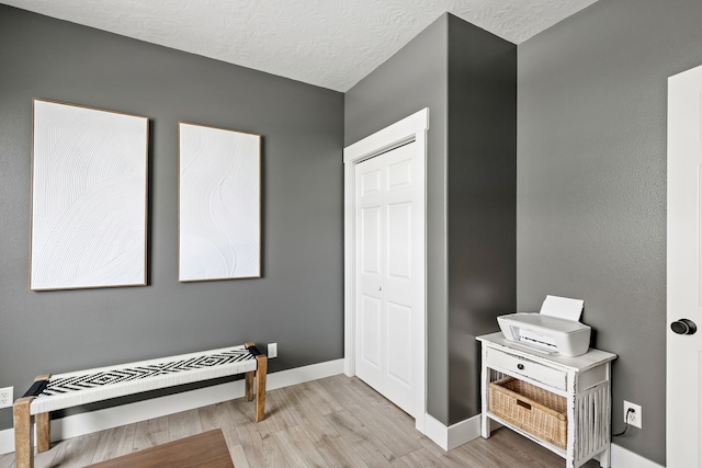 3201 12th St NE, Great Falls, MT 59404 - bedroom featuring a textured ceiling, baseboards, wood finished floors, and a closet