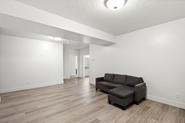 3201 12th St NE, Great Falls, MT 59404 - sitting room featuring baseboards, light wood-type flooring, and a textured ceiling