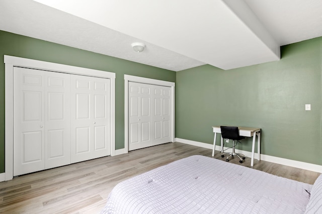 3201 12th St NE, Great Falls, MT 59404 - bedroom with multiple closets, baseboards, and wood finished floors