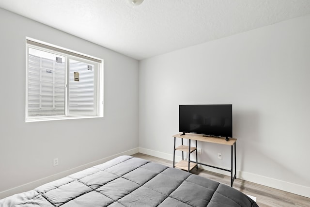 3201 12th St NE, Great Falls, MT 59404 - bedroom with baseboards, a textured ceiling, and wood finished floors