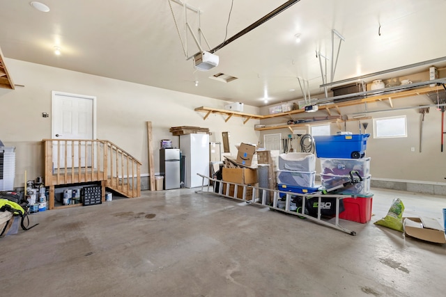 3201 12th St NE, Great Falls, MT 59404 - garage with a garage door opener and freestanding refrigerator