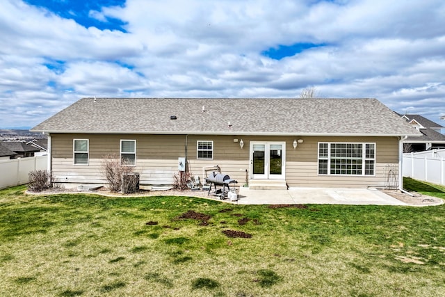 3201 12th St NE, Great Falls, MT 59404 - back of property with a lawn, a fenced backyard, a patio area, and roof with shingles