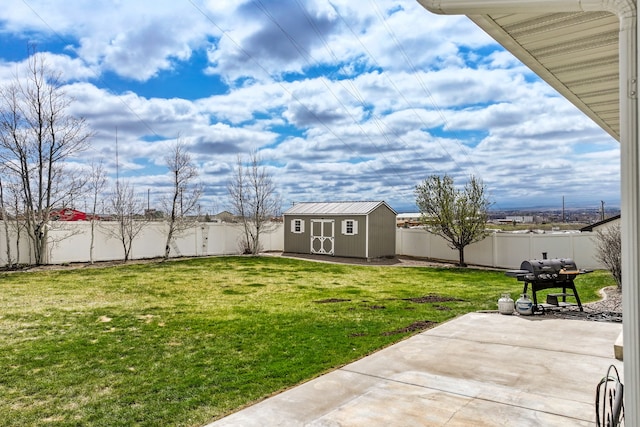 3201 12th St NE, Great Falls, MT 59404 - view of yard with a storage unit, a fenced backyard, a patio area, and an outbuilding