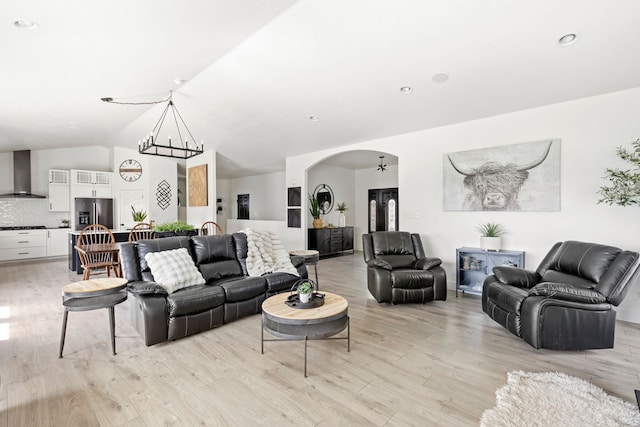 3201 12th St NE, Great Falls, MT 59404 - living room with arched walkways, lofted ceiling, light wood finished floors, and a chandelier