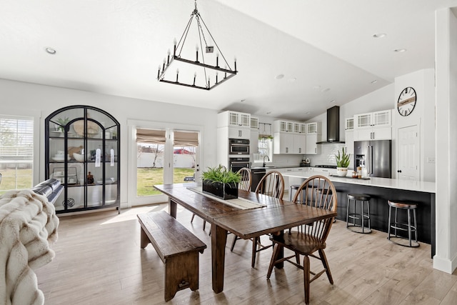 3201 12th St NE, Great Falls, MT 59404 - dining room with a notable chandelier, plenty of natural light, lofted ceiling, and light wood-type flooring