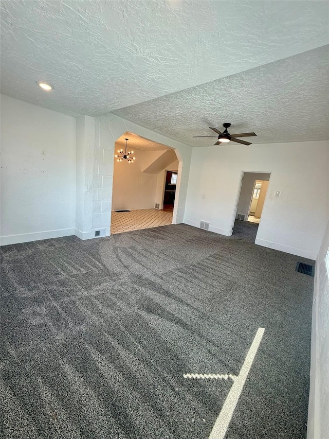 unfurnished living room with visible vents, arched walkways, baseboards, and carpet flooring