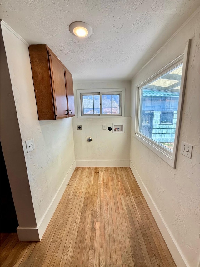 washroom with light wood-style floors, hookup for a washing machine, a textured ceiling, baseboards, and hookup for an electric dryer