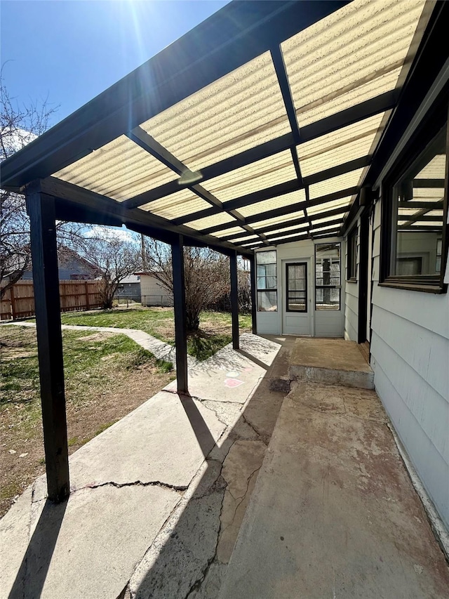 view of patio with fence and a carport
