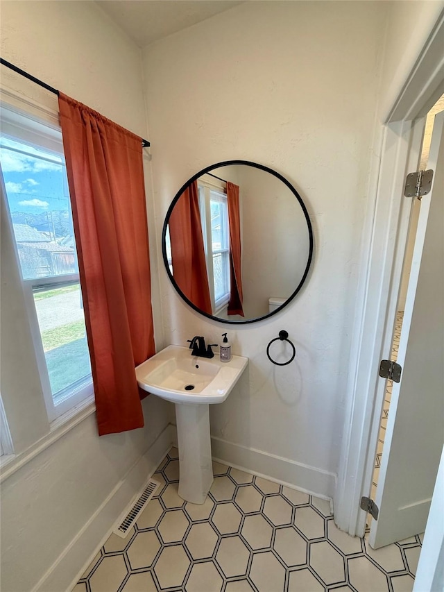bathroom with baseboards and visible vents