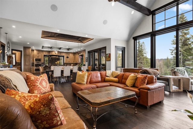 living area featuring high vaulted ceiling, a raised ceiling, beamed ceiling, recessed lighting, and hardwood / wood-style floors