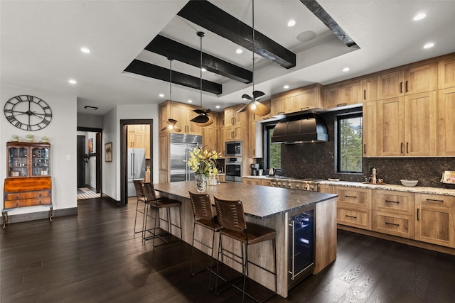 kitchen featuring built in appliances, beverage cooler, recessed lighting, and tasteful backsplash
