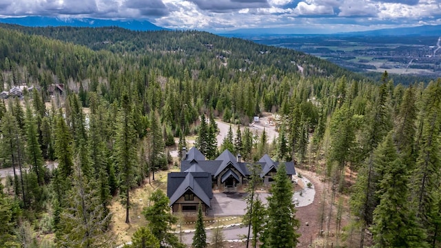 drone / aerial view featuring a forest view and a mountain view