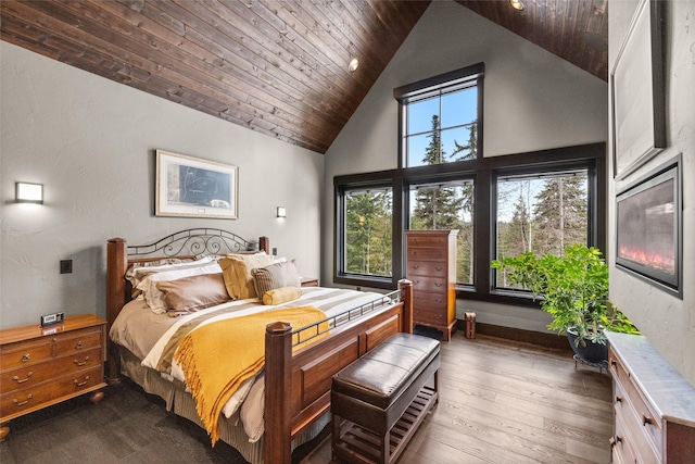 bedroom featuring high vaulted ceiling, dark wood-style floors, and wooden ceiling